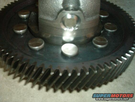 Close-up of a large gear with several bolts around its center