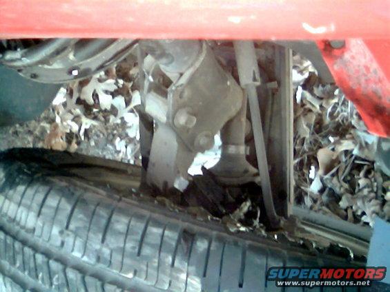Undercarriage of a vehicle with a tire and suspension components visible