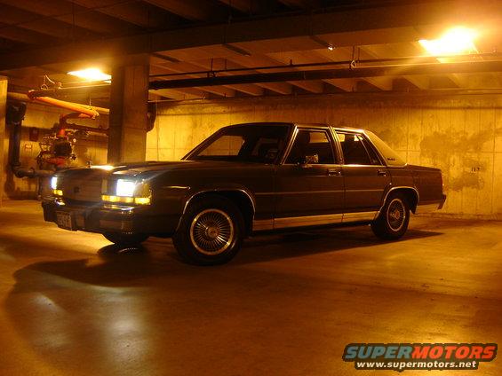 Dark 1988 Ford Crown Victoria LTD sedan, 3/4 front view, parked indoors