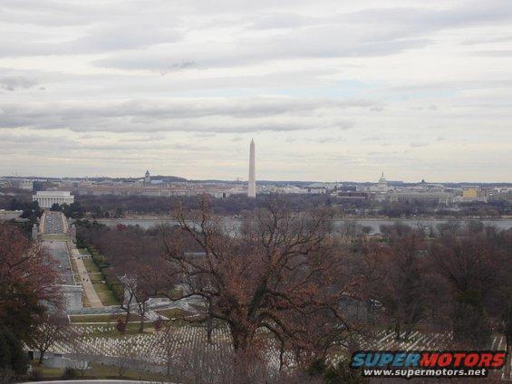 Washington Monument and Capitol Building visible in D.C. skyline with a cemetery in the foreground