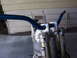 1999 Honda CR250R - Motorcycle handlebars and front forks with a visible part number sticker.