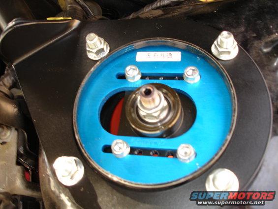 Blue adjustable strut mount with visible text label
