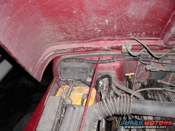 1998 Jeep TJ engine bay showing battery, fuse box, and air intake