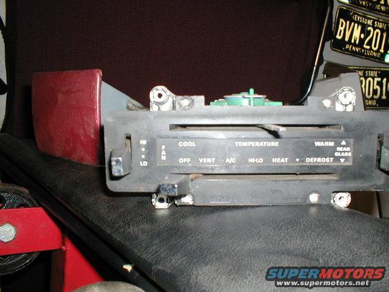 Car climate control panel with labels for COOL, TEMPERATURE, WARM, FAN, OFF, VENT, A/C, HI-LO, HEAT, and DEFROST