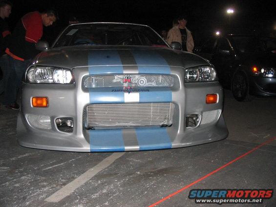 Silver Nissan Skyline GT-R with blue racing stripes and an intercooler
