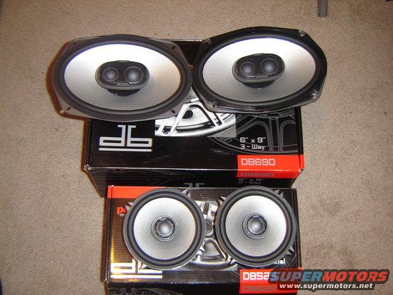 Two pairs of oval and round car speakers on boxes