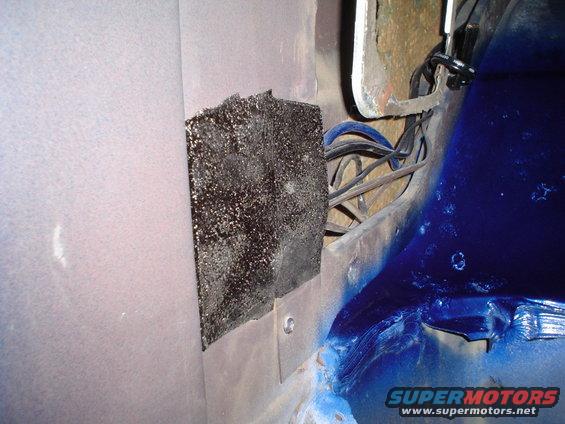 Close-up of vehicle interior showing sound deadening material and wiring harness