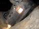1996 Jeep Cherokee - An overturned black SUV is stuck in a dirt ditch with its headlights illuminated.