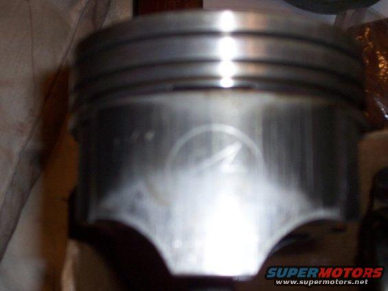 Piston with circular logo