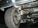 1989 Ford Bronco - Undercarriage view of a 1989 Ford Bronco, showing the front suspension and undercoating.
