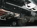 1989 Ford Bronco - The underside of a vehicle is shown, revealing its frame, exhaust system, and rear axle.