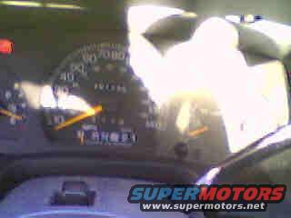 Car dashboard with speedometer, odometer, and gear indicator. Supermotors.net logo visible