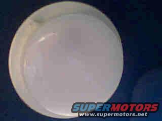 Close-up of a plain white hubcap with a Supermotors.net logo at the bottom