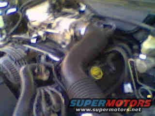 Engine bay with air intake tube and yellow cap