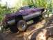 2001 Dodge 1500 - A modified 2001 Dodge 1500 pickup truck navigates a steep, rocky incline off-road.