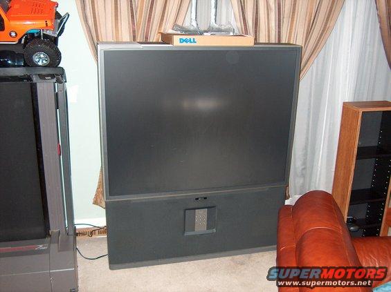 Large dark television with a Dell box on top