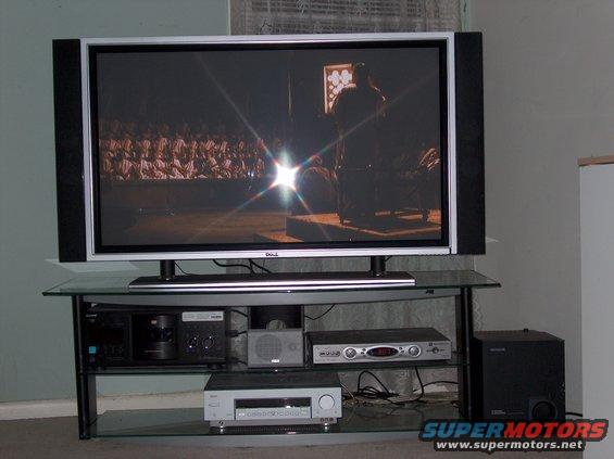 Television on a glass stand with audio equipment below