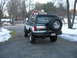 1994 Ford Bronco - A lifted Ford Bronco is parked in a driveway with snow on the ground and trees in the background.
