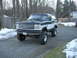 1994 Ford Bronco - This lifted Ford Bronco features a distinctive two-tone paint scheme and prominent aftermarket wheels.