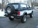 1994 Ford Bronco - This Ford Bronco features a two-tone paint scheme and a rear-mounted spare tire.