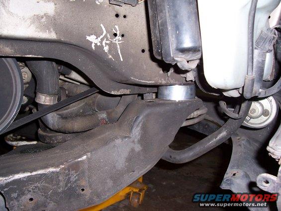 Vehicle suspension components with a silver spacer, black belt, and yellow jack