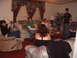 1988 Ford Bronco - A group of people are socializing in a living room, with some seated on couches and others standing.