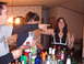 1988 Ford Bronco - People are gathered around a bar filled with bottles of alcohol, with one person pointing.