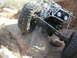 1984 Ford Bronco - Custom off-road buggy navigating difficult terrain on a rocky trail.