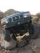1984 Ford Bronco - Ford Bronco navigating a rocky trail, showing off its off-road capabilities.