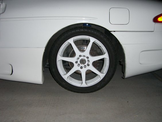 White 1996 Ford Probe rear wheel with aftermarket white rims