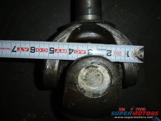 Close-up of a universal joint with a tape measure showing approximately 3.5 inches