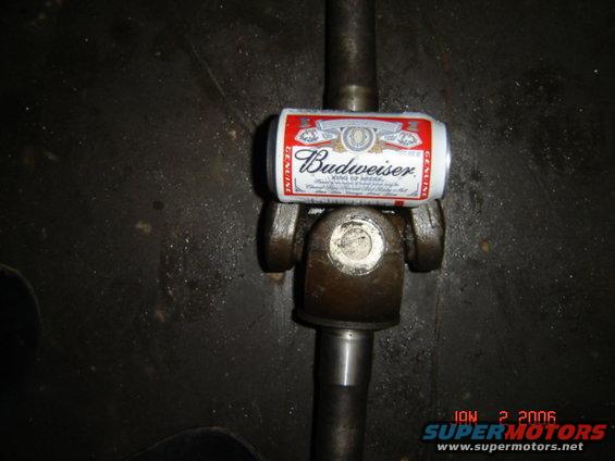 Driveshaft universal joint with a Budweiser can on top. Date stamp reads JAN 2 2006