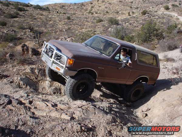 Brown Ford Bronco navigating rocky terrain