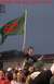 1996 Ford Probe - A celebratory crowd raises a flag with 'BS' on it, under a sky with text overhead.