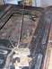 1978 Ford Bronco - The internal mechanism of a vehicle's tailgate latch shows significant rust and wear.
