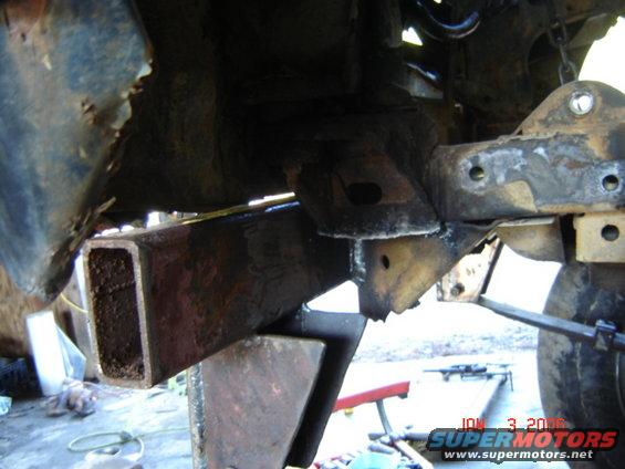 Rusted frame and suspension parts, close-up view