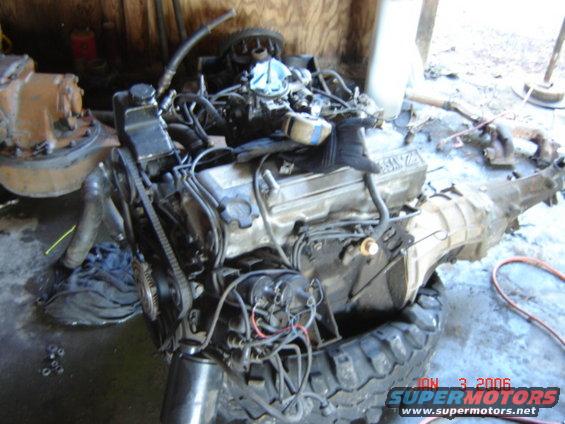 Nissan Z24 engine and transmission assembly, with hoses and belts visible