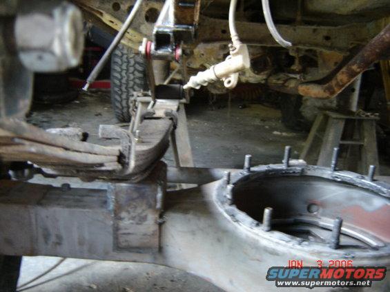 Truck leaf spring and differential housing under repair, with a date stamp of JAN 3 2006
