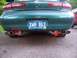 1996 Mercury Sable - The rear of a green sedan is shown, dual exhaust pipes and a Michigan license plate.
