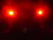 1989 Jeep YJ - The image shows two bright red lights illuminated against a dark background, with a website watermark visible.