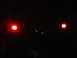 1989 Jeep YJ - A dark image shows the rear of a vehicle with illuminated taillights and a spare tire mount.