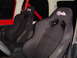 1989 Jeep YJ - Interior view of a vehicle showing two aftermarket racing seats with an American flag emblem.