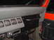 1989 Jeep YJ - Close-up of the dashboard and interior door panel of a Jeep, showing gauges and a grab handle.