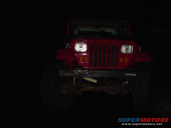 Red 1989 Jeep YJ front view with aftermarket bumper