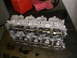 1997 Mitsubishi Eclipse - A disassembled engine cylinder head with visible camshafts and intake ports.
