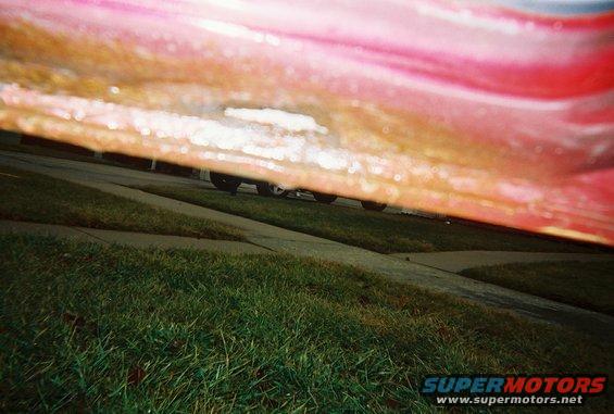 Small rust hole, bottom of passenger door.