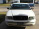 2000 Ford Crown Victoria - Front view of a white 2000 Ford Crown Victoria, a black grille and a license plate.