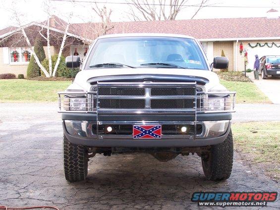 Front view of a white 1997 Dodge 2500 pickup truck with a Confederate flag license plate