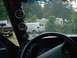 2001 Dodge 1500 - Interior view of a vehicle with gauges and steering wheel, showing other vehicles and buildings through the windshield.