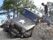 2004 Jeep Wrangler - This Jeep Wrangler is navigating a challenging off-road obstacle with assistance from onlookers.
